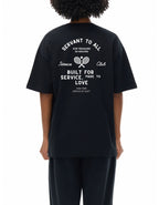 Person wearing a black t-shirt with white text and graphics on the back stating servant to all for treasure in heaven. 