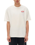 Person wearing a white t-shirt with red text saying told to love your neighbor