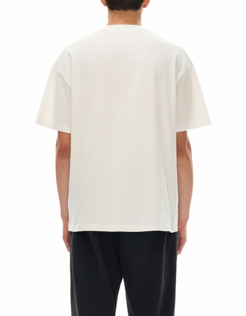 Person wearing a plain white t-shirt on a white background