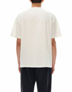 Person wearing a plain white t-shirt on a white background