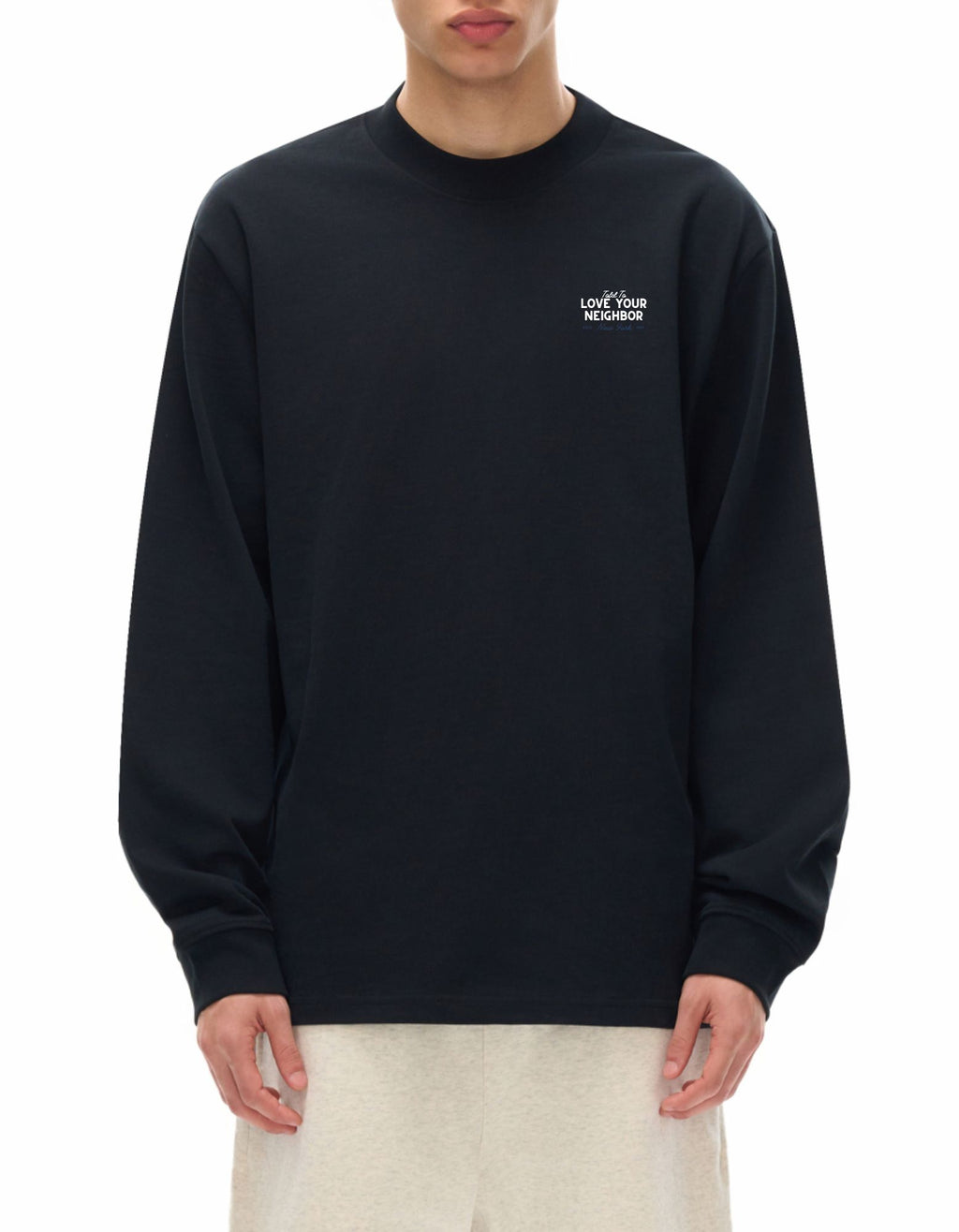 Person wearing black long sleeve t-shirt with "Told to love your neighbor" on the chest in white text