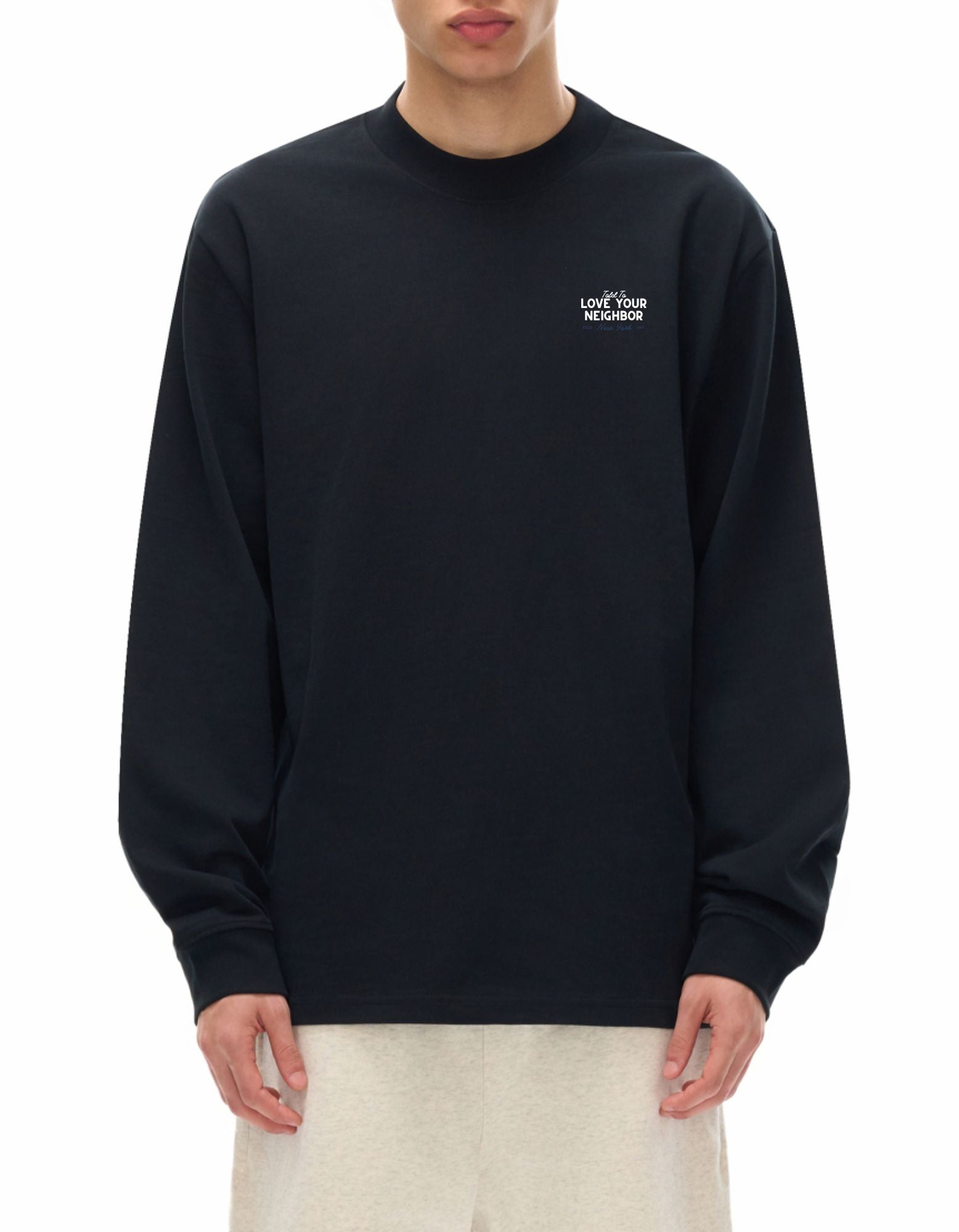 Person wearing black long sleeve t-shirt with "Told to love your neighbor" on the chest in white text