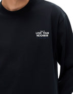 Black long sleeve t-shirt with "Told to love your neighbor" on the chest in white text