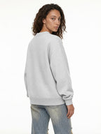 grey christian crewneck with a women in front a white background