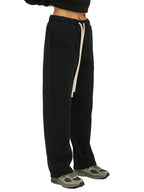 Black sweatpants with a white stripe on a white background