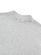 Close-up of a gray sweatshirt collar on a white background. grey christian crewneck.