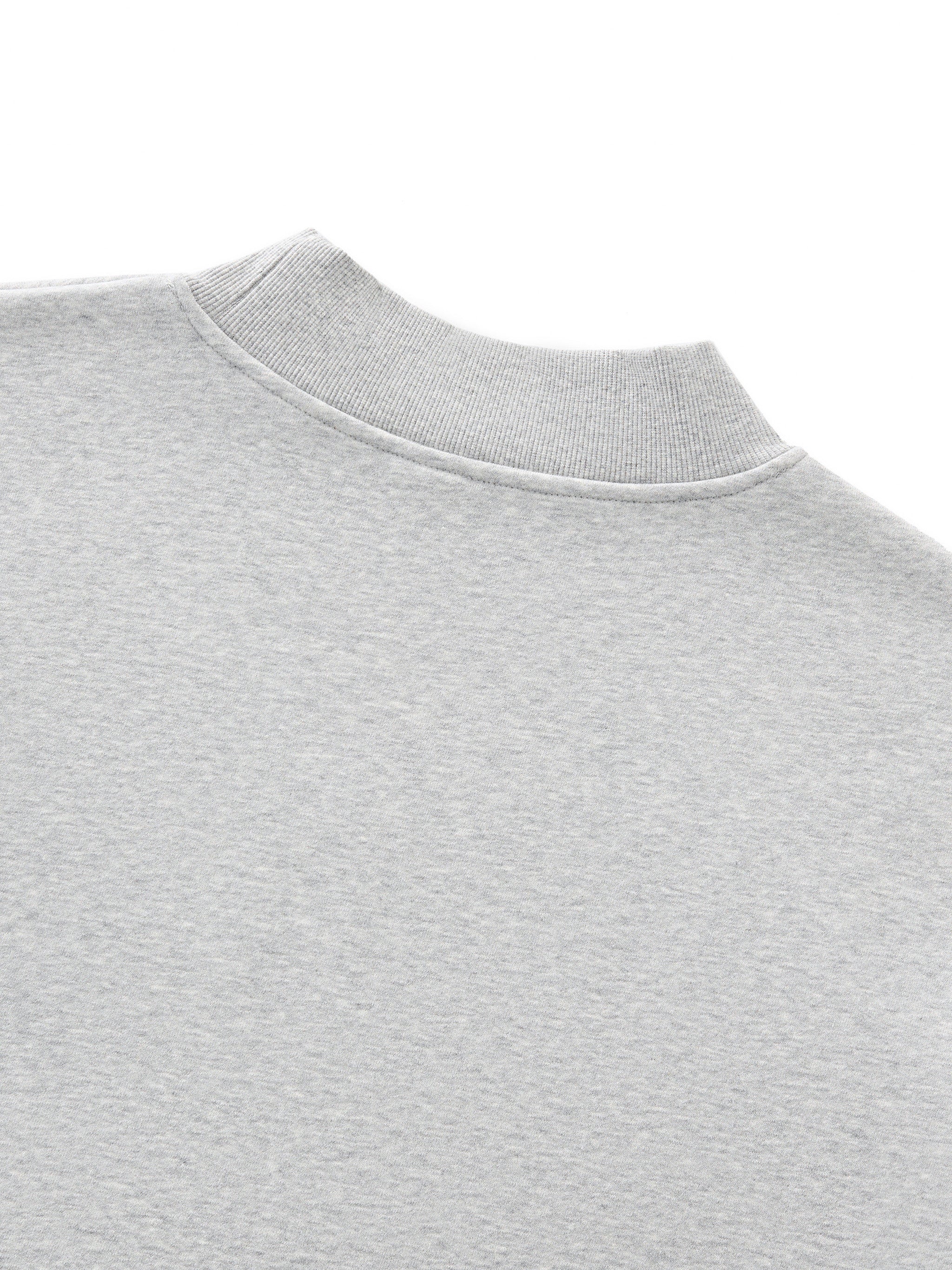 Close-up of a gray sweatshirt collar on a white background. grey christian crewneck.