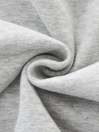 Close-up of gray fabric with a focus on texture and folds. grey christian crewneck