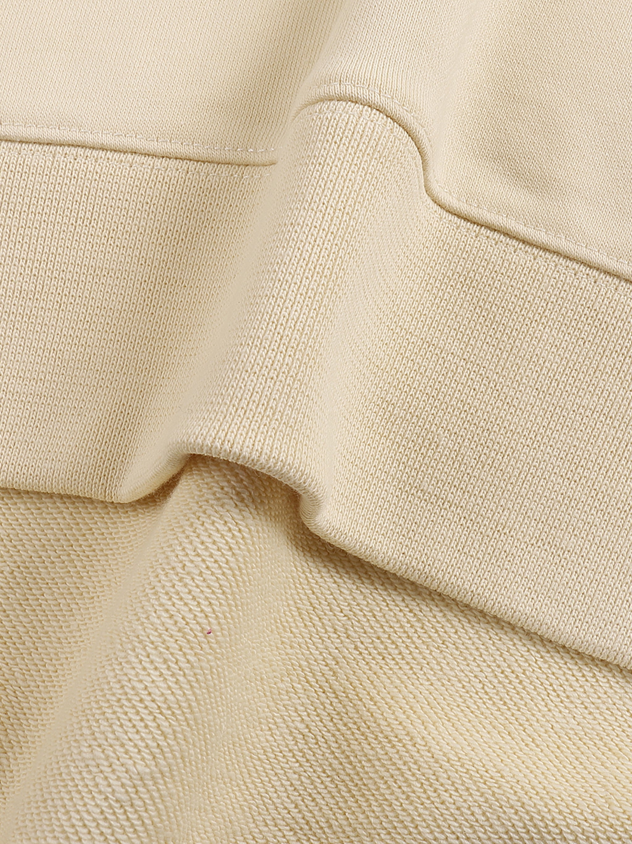 apricot crewneck hem fabric details. 100% cotton.