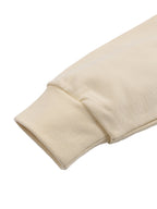 apricot crewneck sleeve fabric details. 100% cotton.
