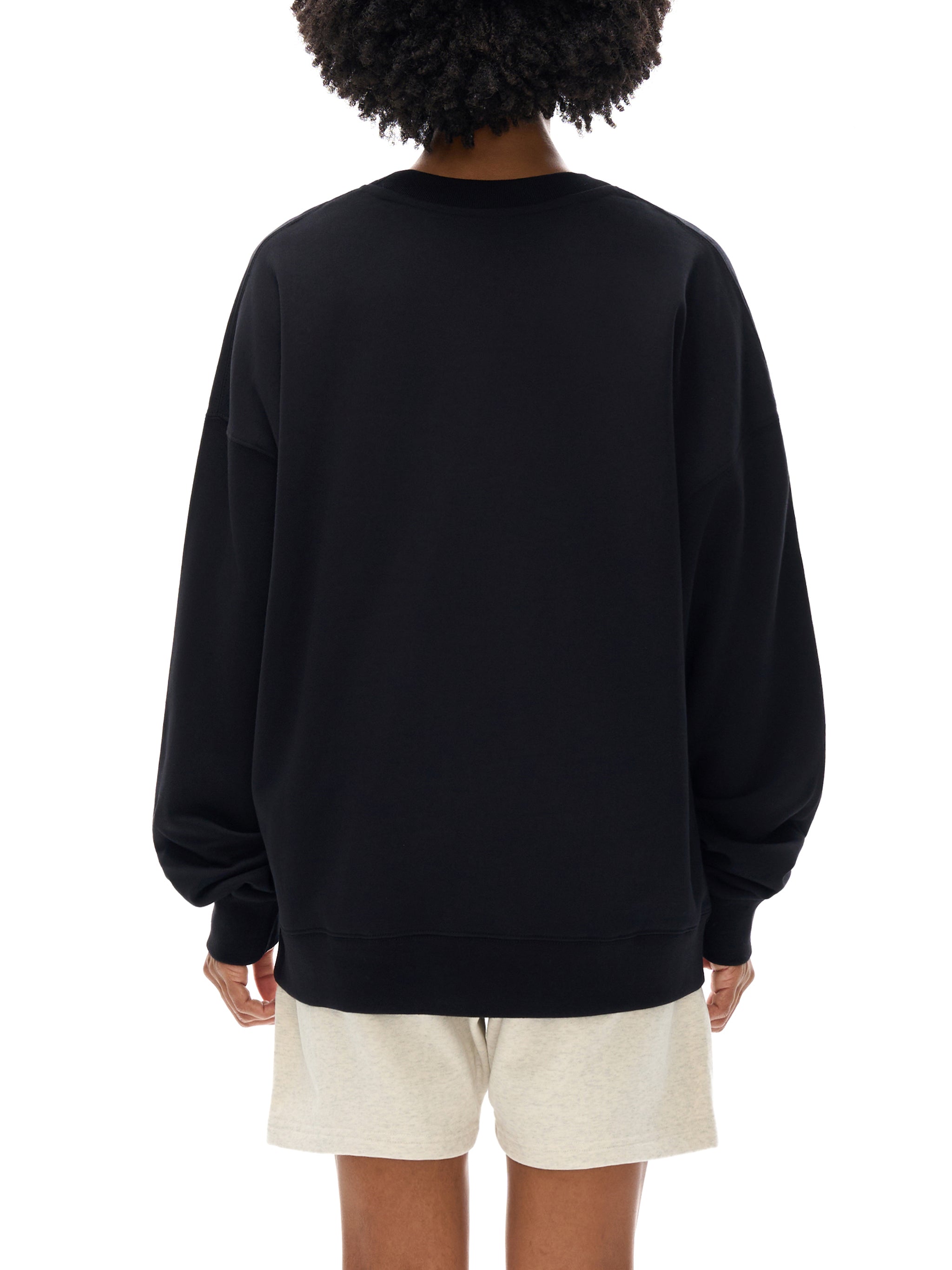 woman in black crewneck with no text on the back.
